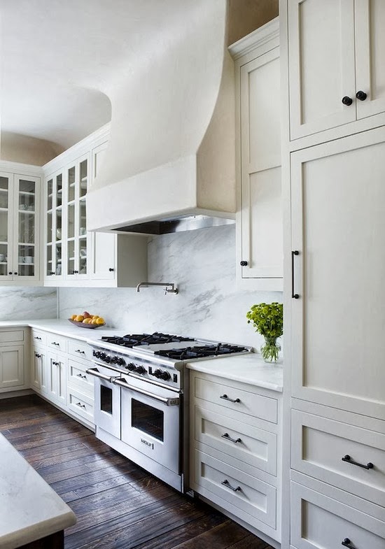 white kitchen, white massive stove hood, dark floors