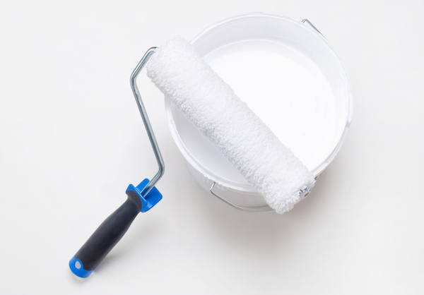 best white wall paint in bucket with a roller