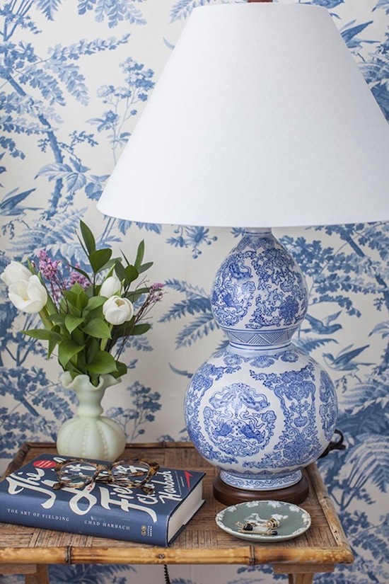 vignette with flowers and a blue and white table lamp