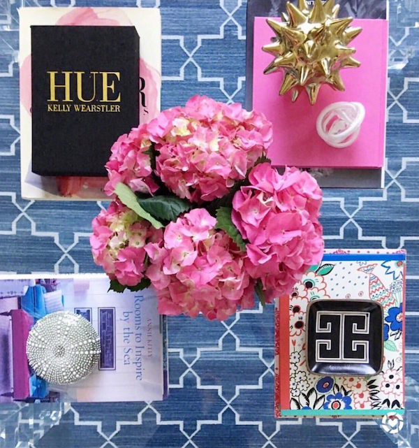 flowers and coffee table books on glass table.
