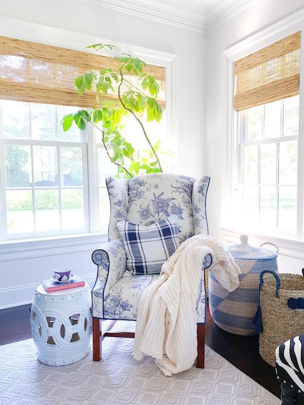 corner of room with two windows and bamboo blinds