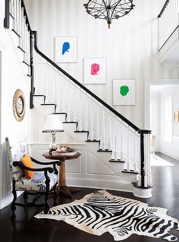 How To Decorate A Staircase Wall example of a front entry staircase with art going up the wall