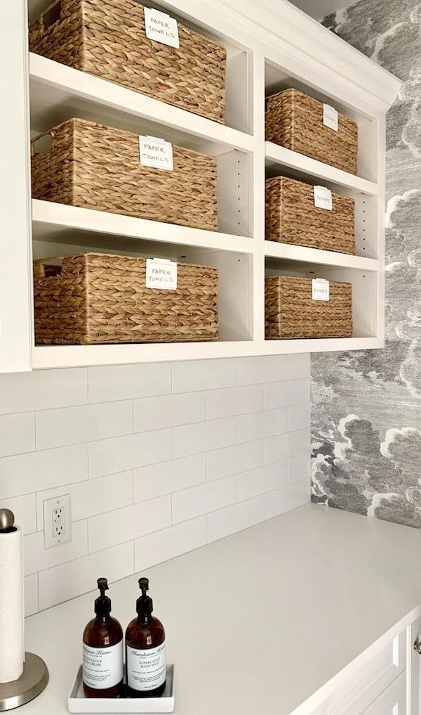 laundry room with clever home storage solutions, baskets on shelves for cleaners