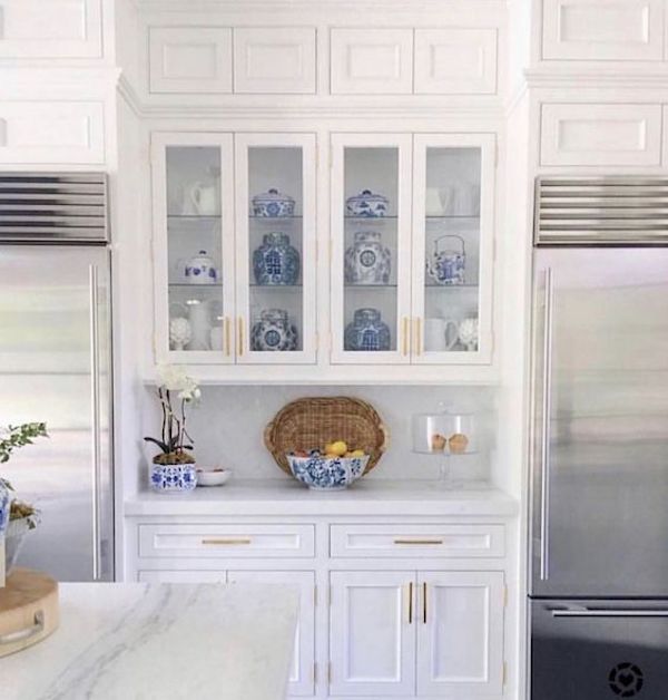 double stainless steel refrigerators in modern all white kitchen