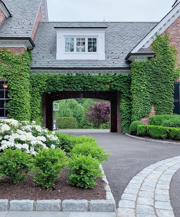 porte cochere covered in Boston Ivy brick walls of home