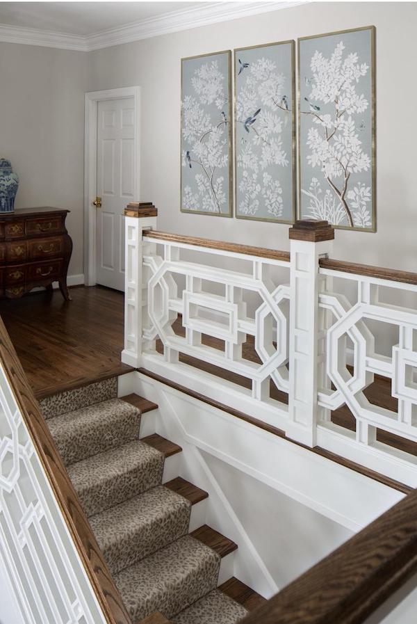 three framed Chinoiserie panels in hallway above staircase