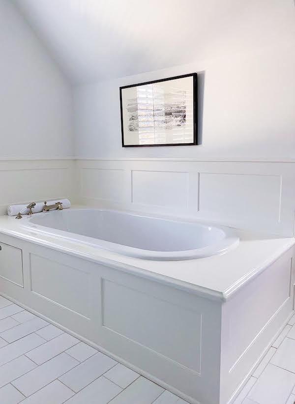 painted over cultured marble white bath tub surround on white tile floor
