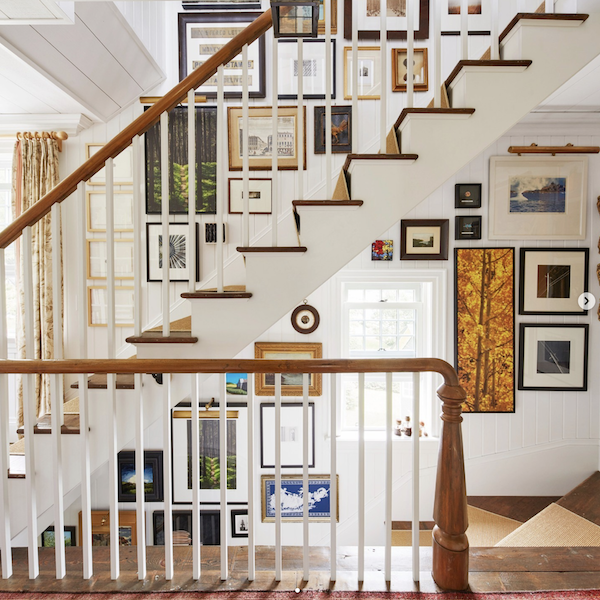 gallery wall of art on a large staircase wall.