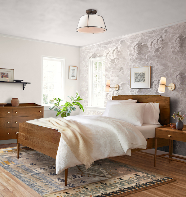 bedroom with wallpaper and flushmount light.