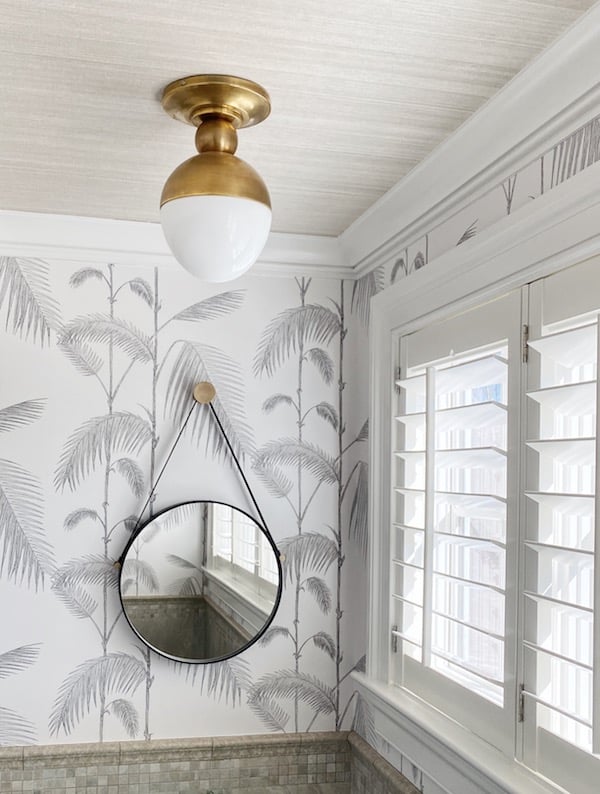 brass flush mount light in powder room