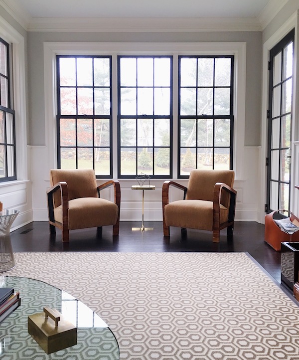 black painted window trim in study with two modern chairs.