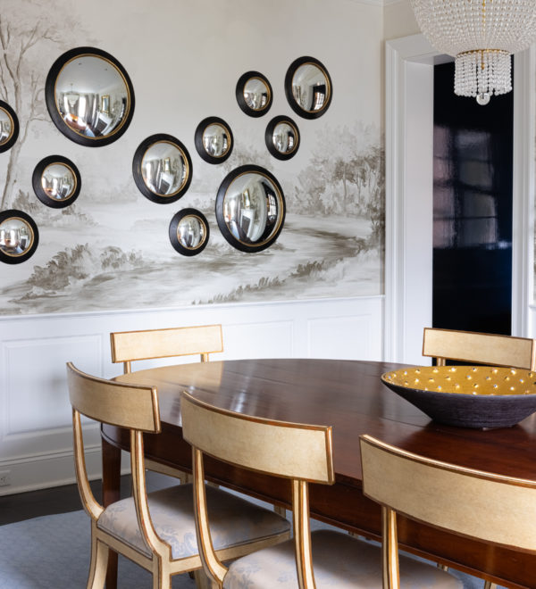 round mirrors in different sizes on mural wallpaper in dining room