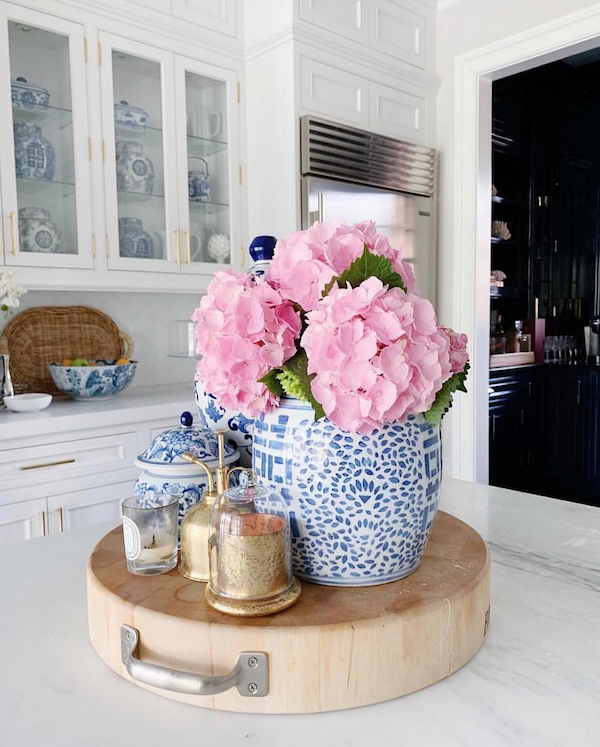kitchen island with a styled vignette and flowers