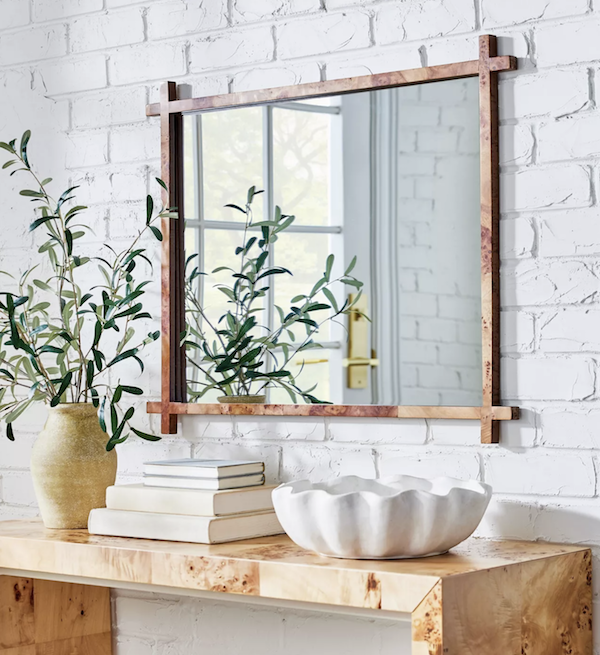 burl wood table in entry with mirror