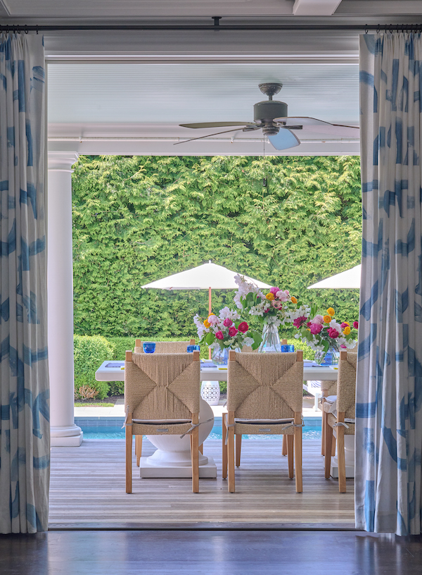 covered porch with outdoor table set for dinner