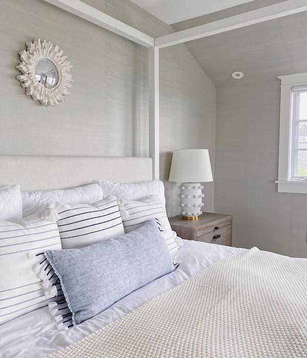 canopy bed with cozy pillows and throws in bedroom