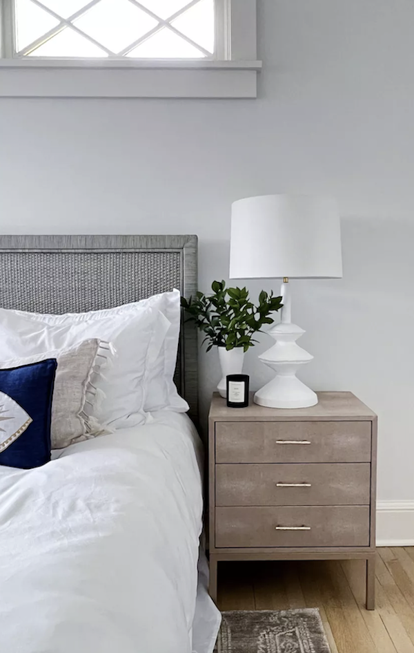 close up of nightstand and bed in beach house.