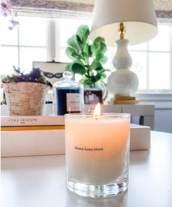 close up of burning candle on a desk.