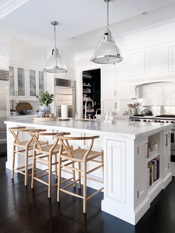 white modern kitchen with wood counter stools