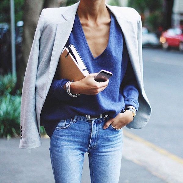 woman on the street with a gray blazer over her shoulders.