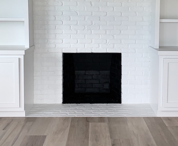 white brick modern fireplace with black interior