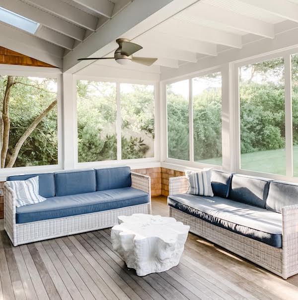 screened in back porch with two sofas