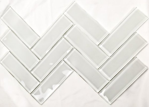 white glass tiles in a herringbone pattern.