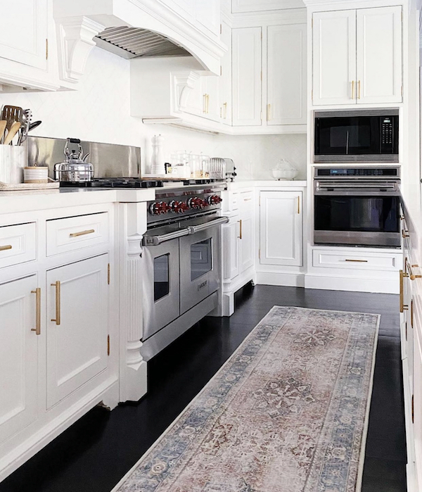 kitchen stove with runner in front of it. 