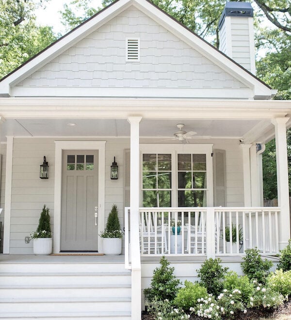 cottage with white front porch painted in Repose Gray.