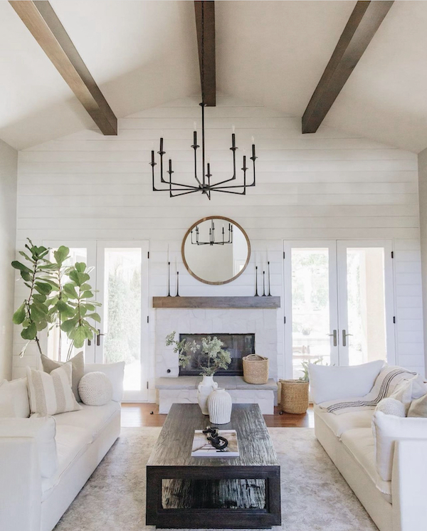 vaulted living room with ceiling beams and fireplace.