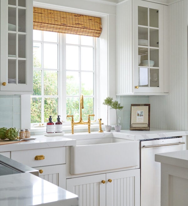 white country kitchen with bamboo shades and farmhouse sink.