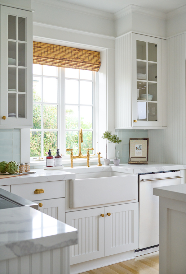 white country kitchen with bamboo shades and farmhouse sink.