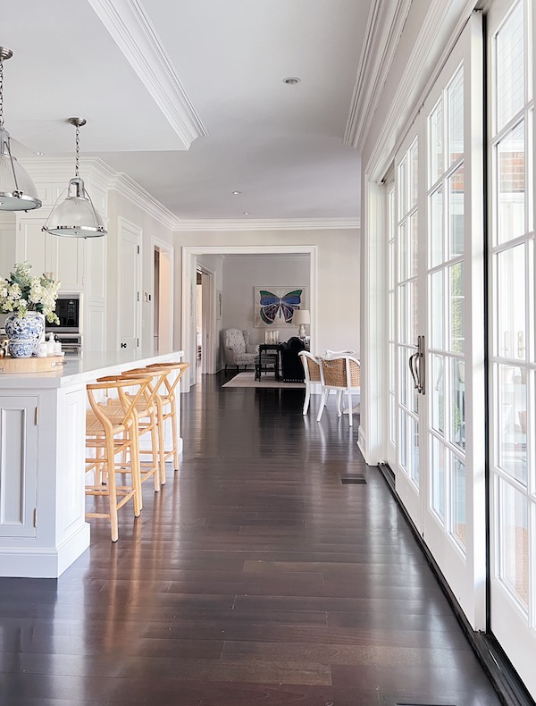 dark hardwood floors in kitchen of large home.