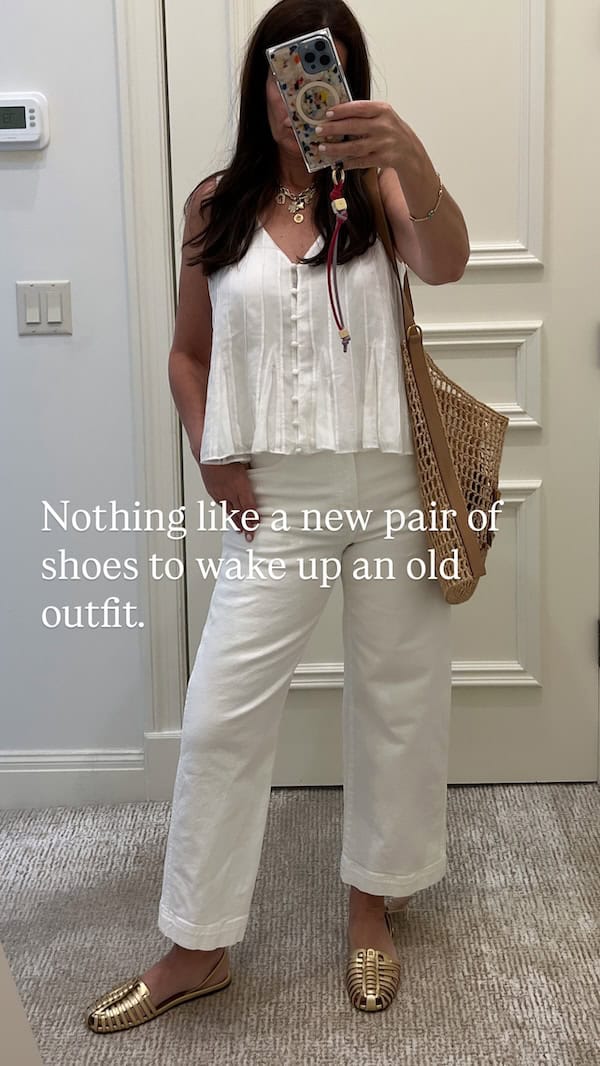 woman in all white outfit with gold flat spring summer sandals.