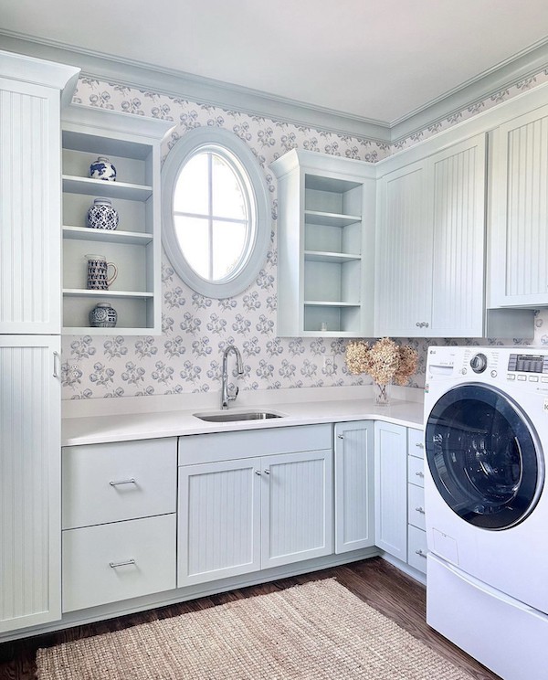 wallpapered laundry room with blue colorful interior trim paint.